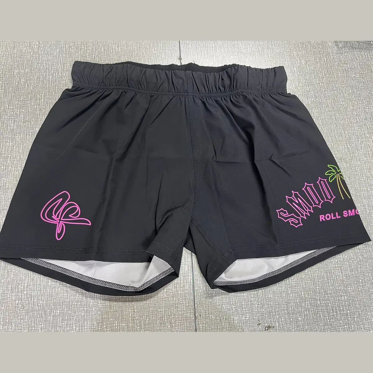 Custom black grappling shorts with printed logos
