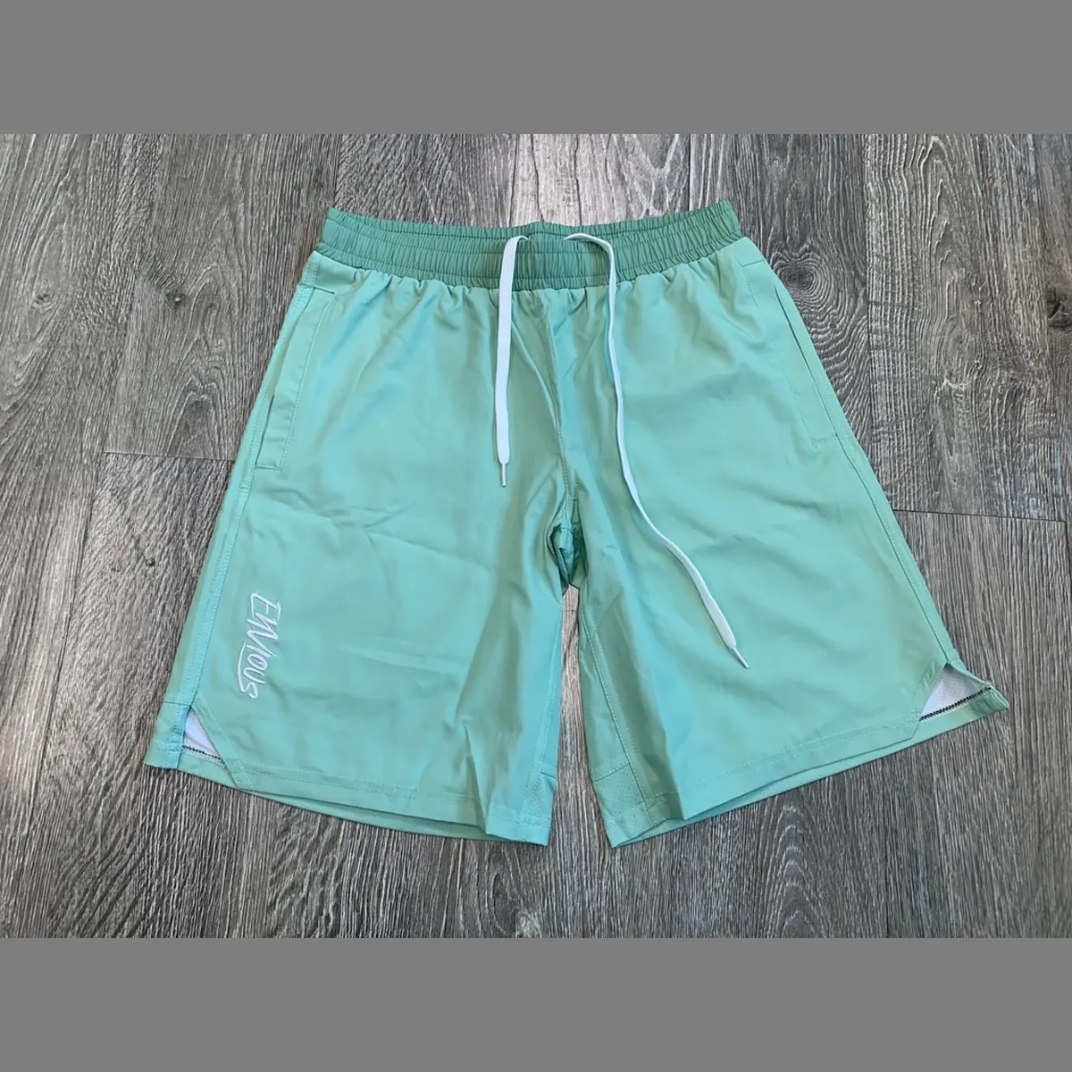 Custom mint green athletic training shorts with drawcord and side splits