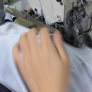 Overlock sewing of a custom team jersey at Glory Ground factory