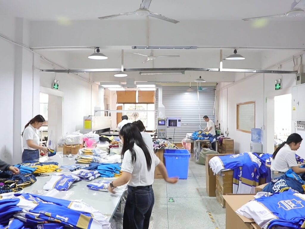 Quality control and packing of custom team uniforms at Glory Ground