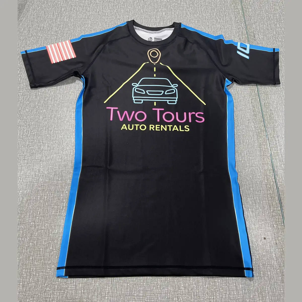 Custom short sleeve ranked rash guard in black with blue side panels, front and back
